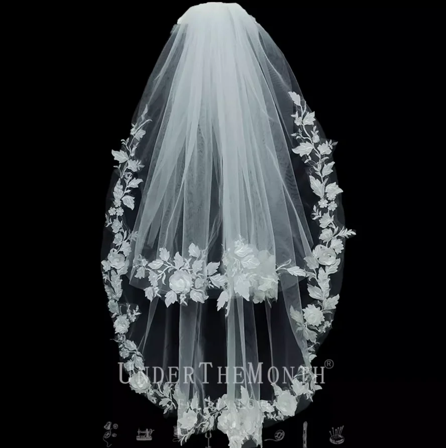 

The bride's wedding veil is a super ethereal, forest-themed double-layered white lace veil, perfect for studio photography.