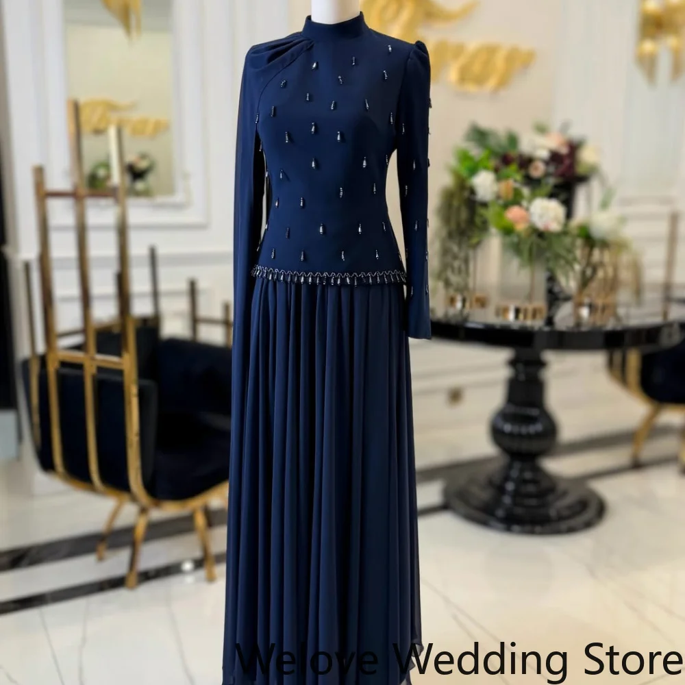 Elegant Navy Blue Formal Maxi Dress Featuring a High Neckline, Long Sleeves, and Sparkling Beaded Embellishments on the Bodice