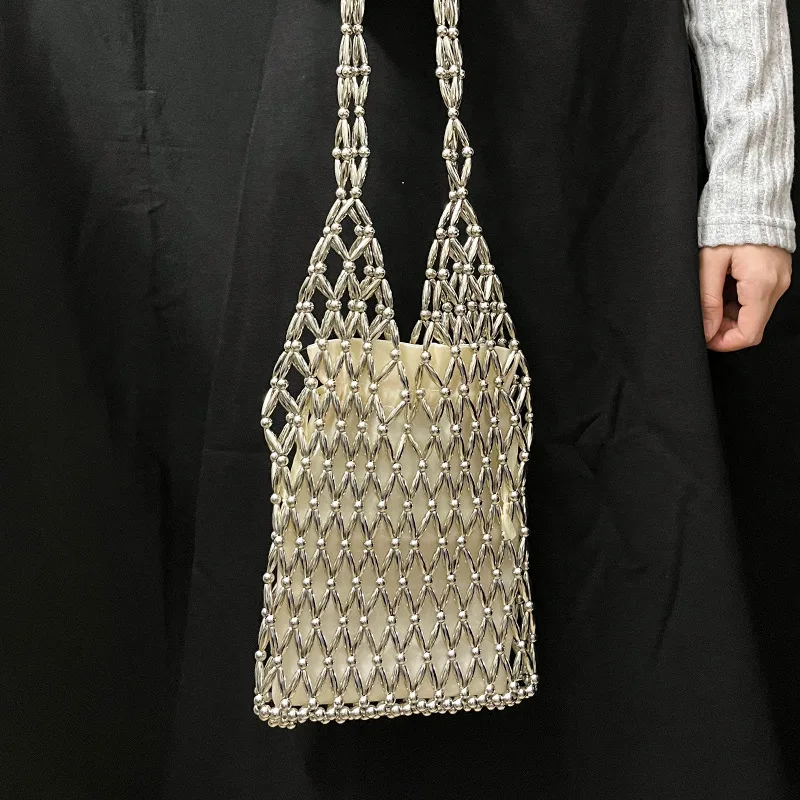 

Fashion imitation pearl hollowed out handmade women's bag with niche design, bucket bag, versatile commuting shoulder bag