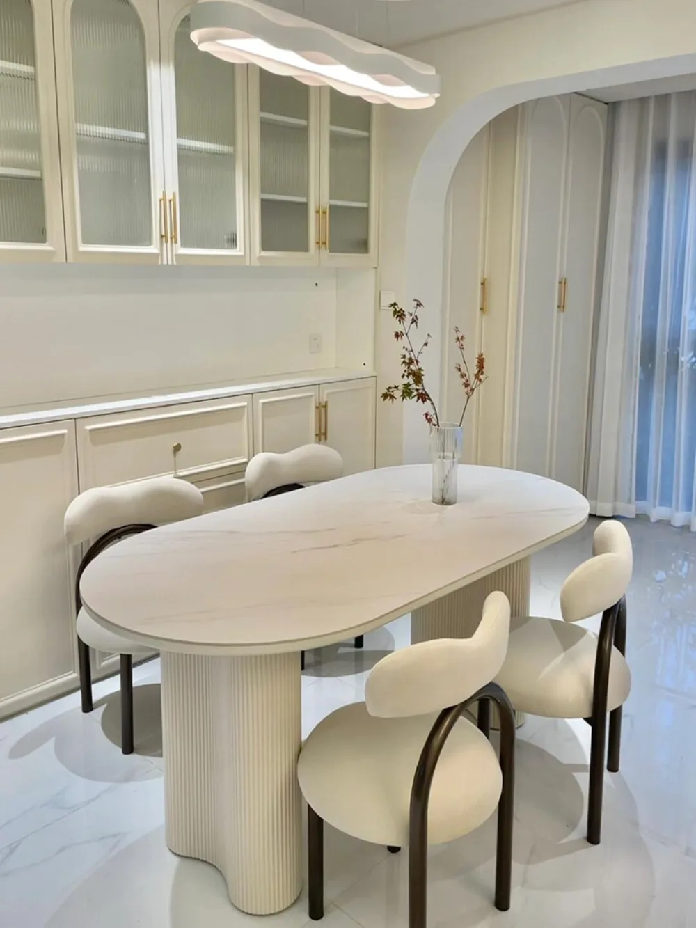 

French rock slab oval dining table cream light luxury high-end modern simple peanut column dining table and chair combination