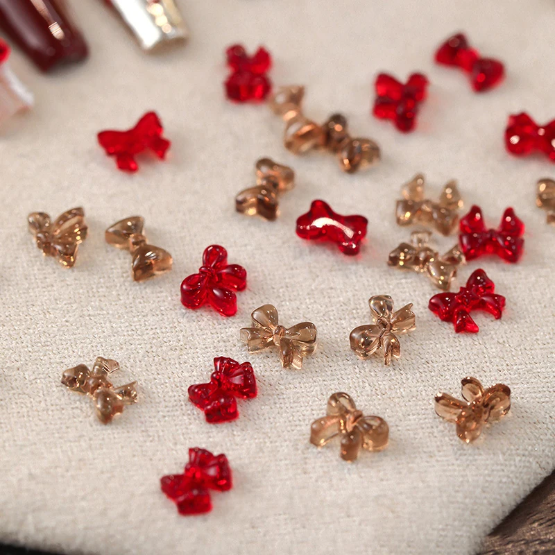 50pcs มินิริบบิ้นเรซิ่นโบว์เล็บ Charms Kawaii MINI Bowknot ผีเสื้อ 3D Rhinestone สําหรับ DIY เกาหลีตกแต่งเล็บ