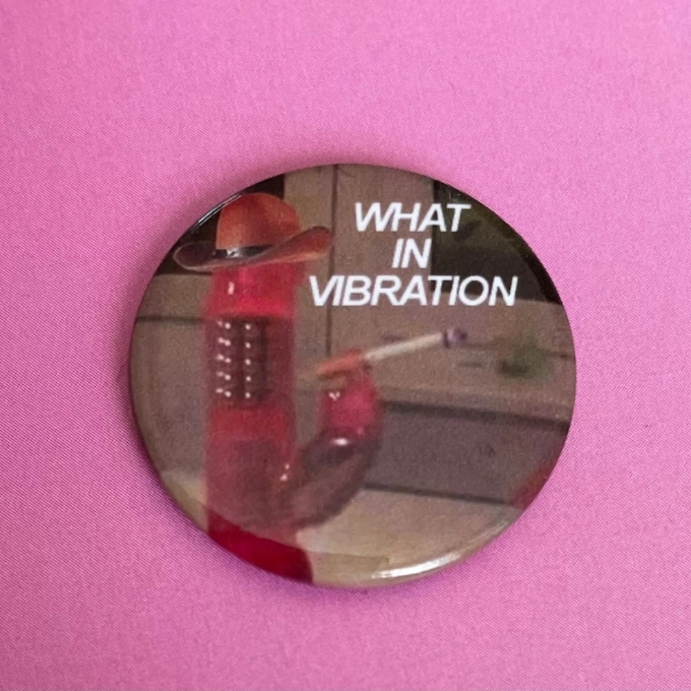 What in Vibration Button Badge