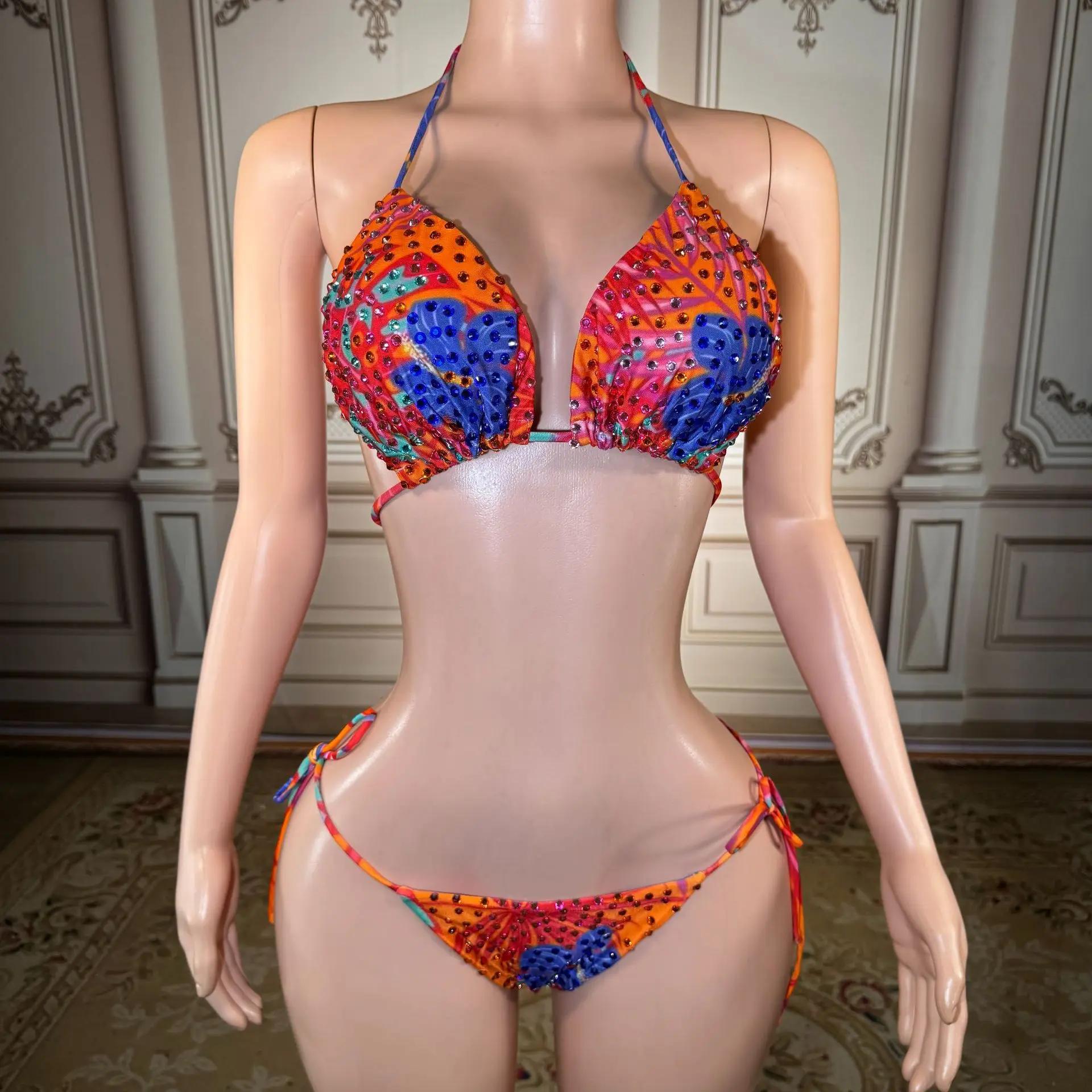 Printed triangular cup-front backless bikini with contrasting blue edges and laces for a beach vacation outfit
