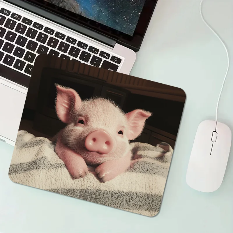 

A pink and cute pig mouse pad with a rubber base is a portable desk pad suitable for office and home rectangular designs