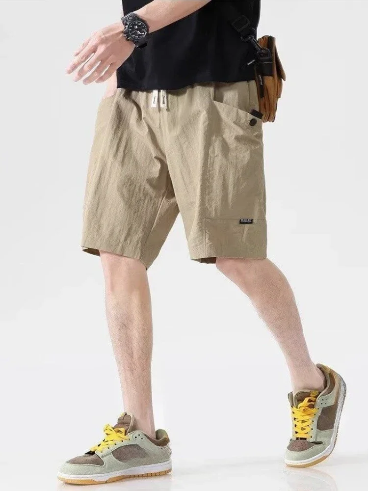 Celana Pendek Pria Bermuda dengan Saku Tali Tarik Celana Pendek Kargo Pria Setengah Panjang Solid Pakaian Vintage Pinggang Elastis Baru Dalam Lebar