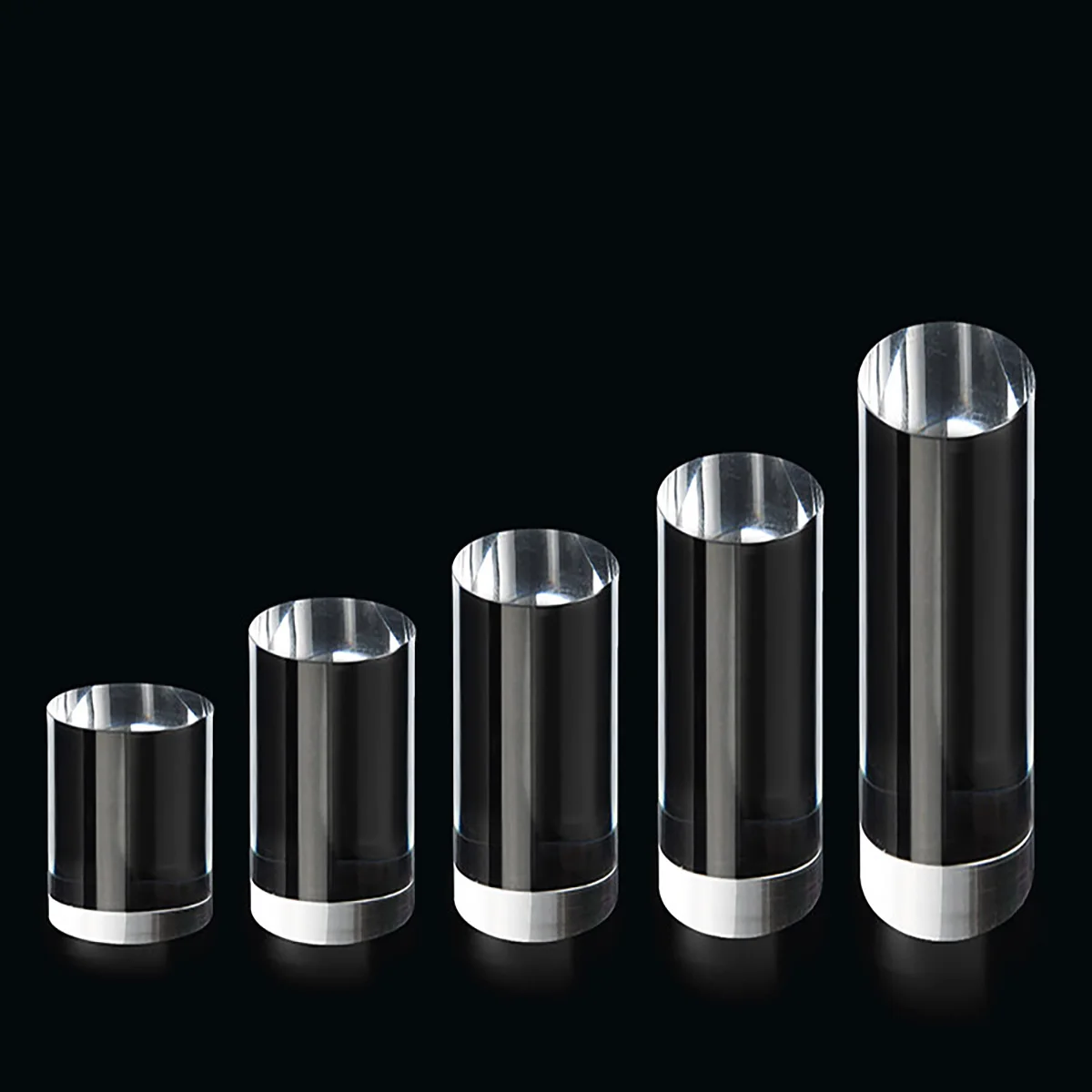 Clear cylindrical display riser pedestal for cosmetic and jewelry showcase