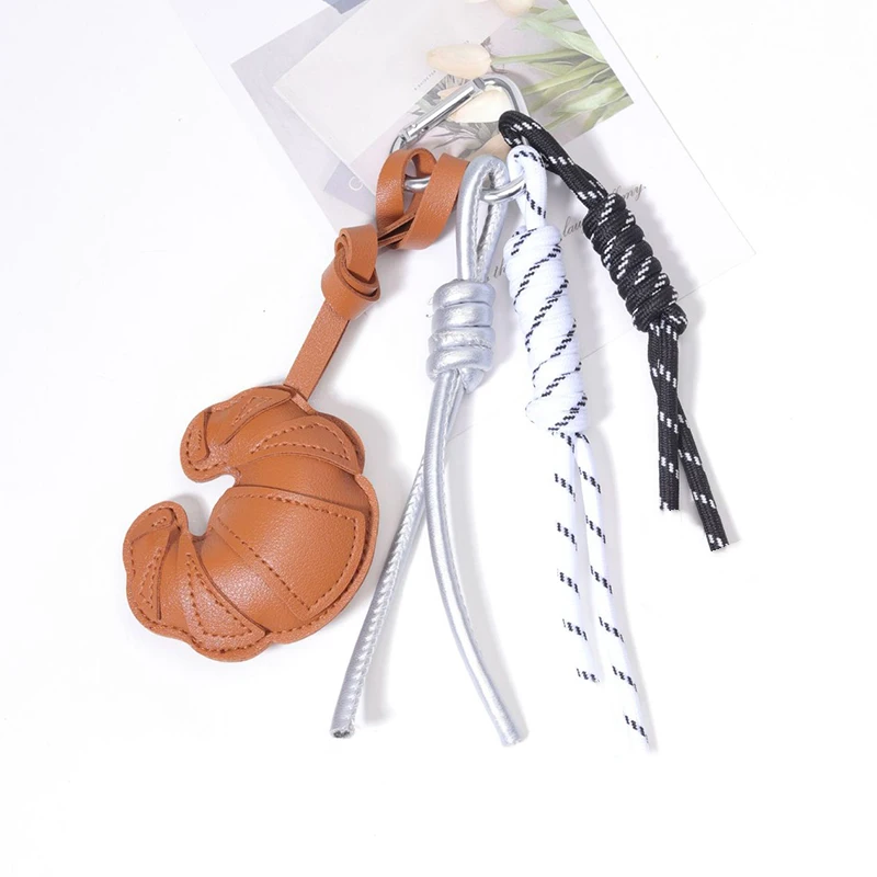 Llavero multifuncional de cuero trenzado DIY, colgante de bolso tipo croissant tejido a mano, adorno antipérdida para mujer