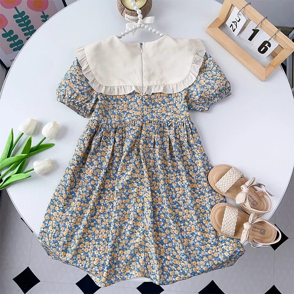 فساتين Bear Leader الصيفية العصرية للفتيات بأكمام قصيرة وطية صدر السترة وديكور فيونكة فستان مطبوع عليه زهور