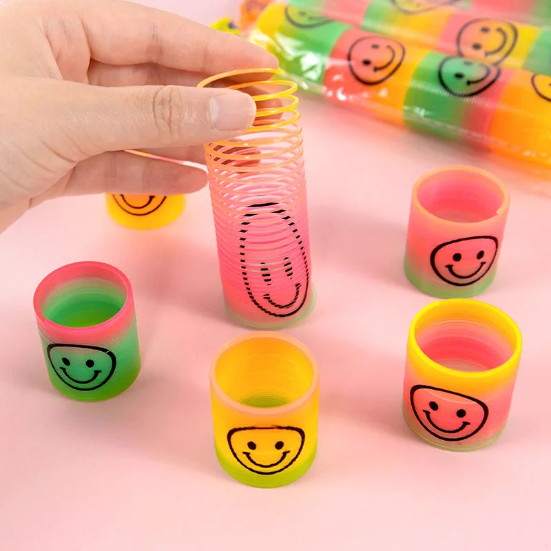 12pcs/lot Funny Creative Magical Folding Toys Plastic Rainbow Circle Smile Pattern Spring Coil Birthday Party Favors Magical Toy