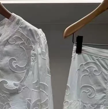 Women's white embroidered two-piece suit with strappy slim-fitting top or stylish midi-length skirt