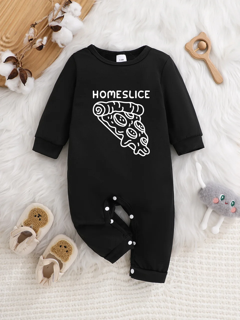 A baby long-sleeved onesie with interesting letter prints. It features a buttoned design for easy putting on and taking off