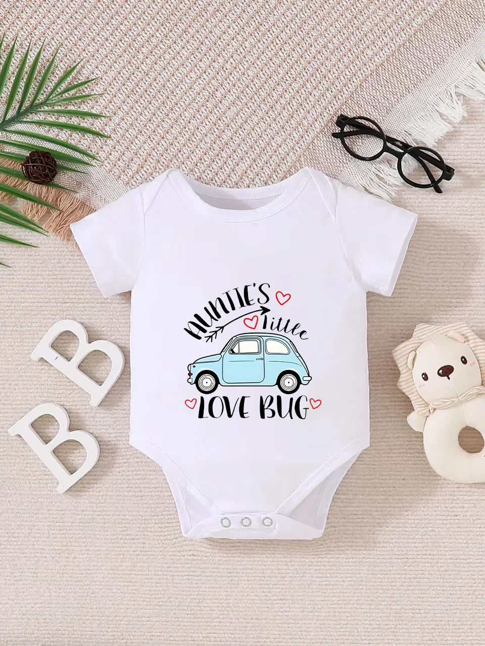 Playful letter-printed baby short-sleeve triangle bodysuit. Button closure for easy dressing, machine washable
