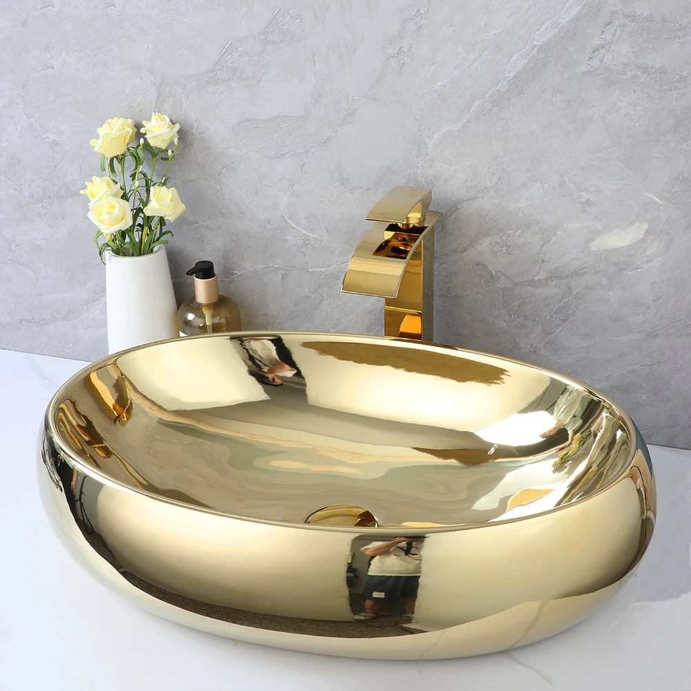 ZAPPO 23 Inch Bathroom Vessel Sink Gold Ceramic Sink Bowl Above Counter Oval Bathroom Sink with Waterfall Faucet Drain Combo