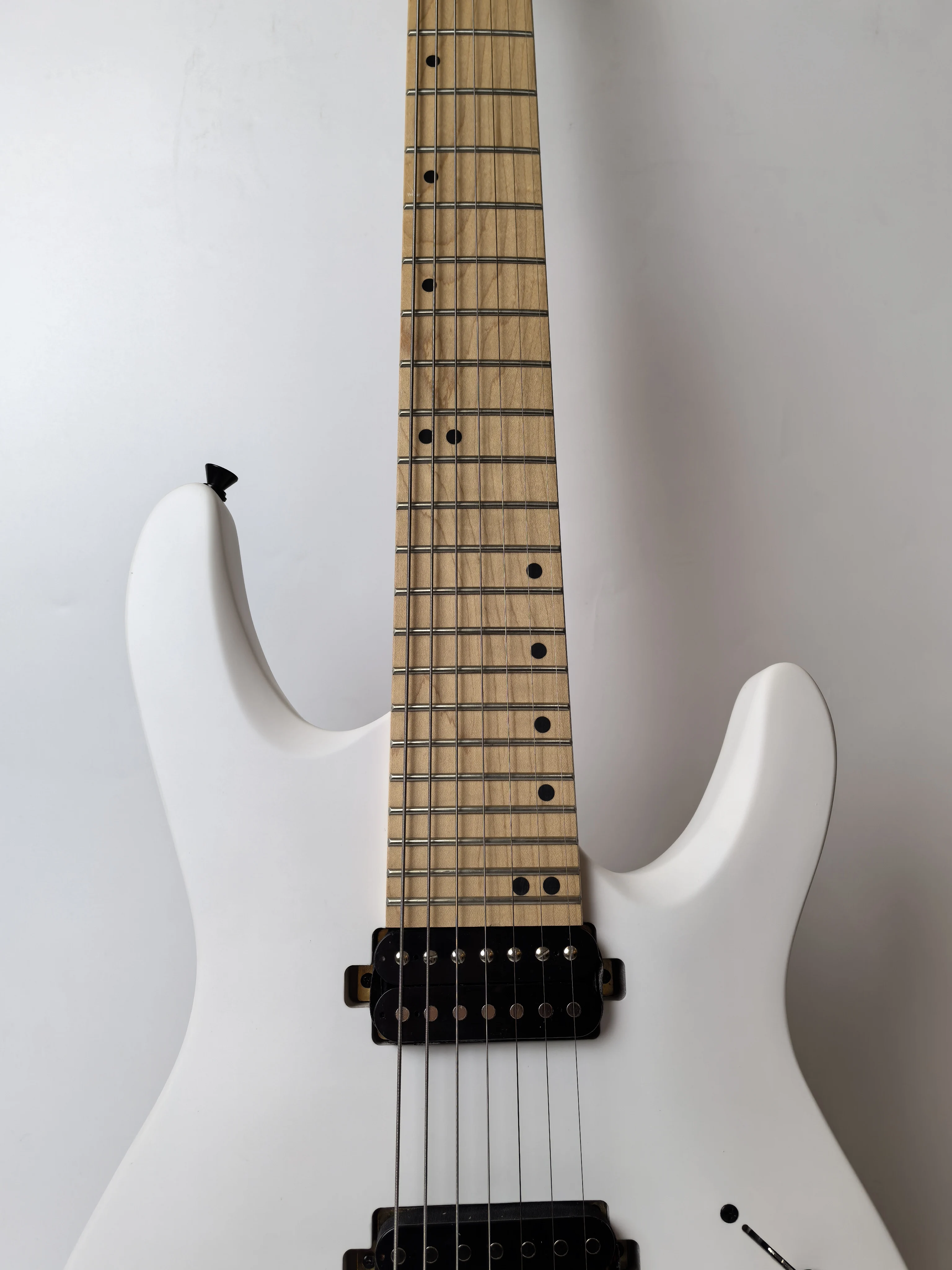 Stock, customizable, factory direct, matte white 7-string Okouman electric guitar, ready to ship when you place an order!