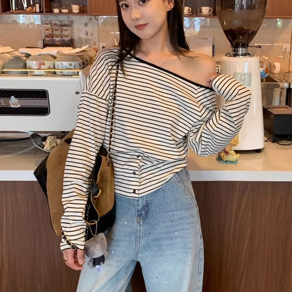 قميص نسائي بأكمام طويلة للربيع والخريف بتصميم بسيط بكتف واحد وياقة مشقوقة مع تفاصيل أزرار وخطوط، مناسب للارتداء اليومي