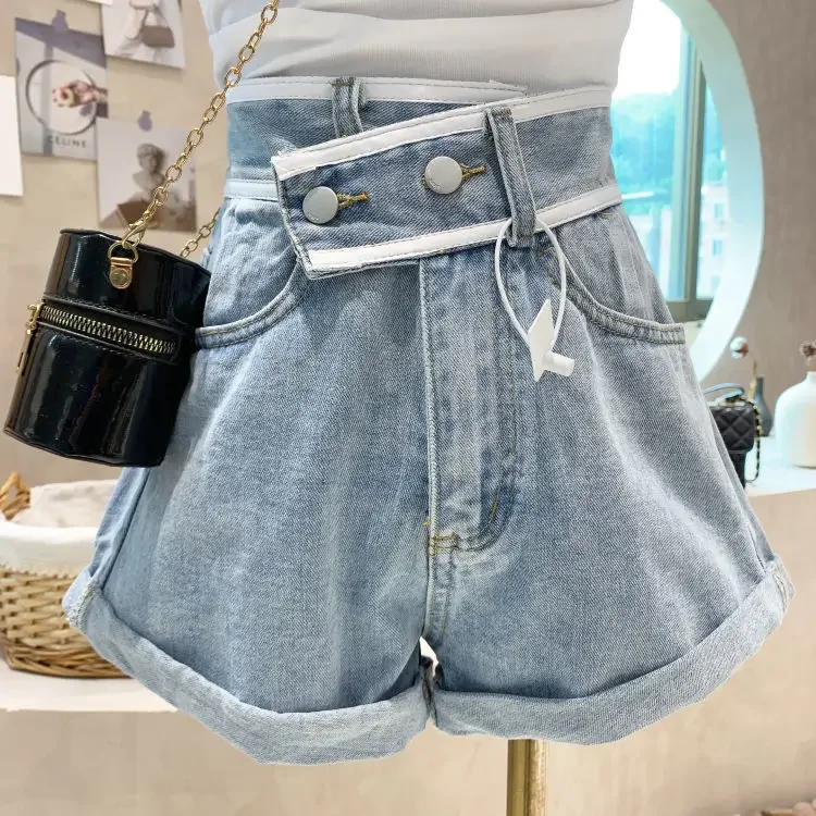 Slant waist design denim shorts female autumn 2024 new high waist loose hemming Joker slim A-shaped wide-leg hot pants.