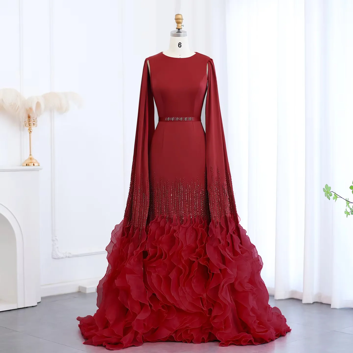 This red mermaid evening gown features long cape sleeves and 3D ruffled hem. Custom sizes available. Perfect for prom, wedding a