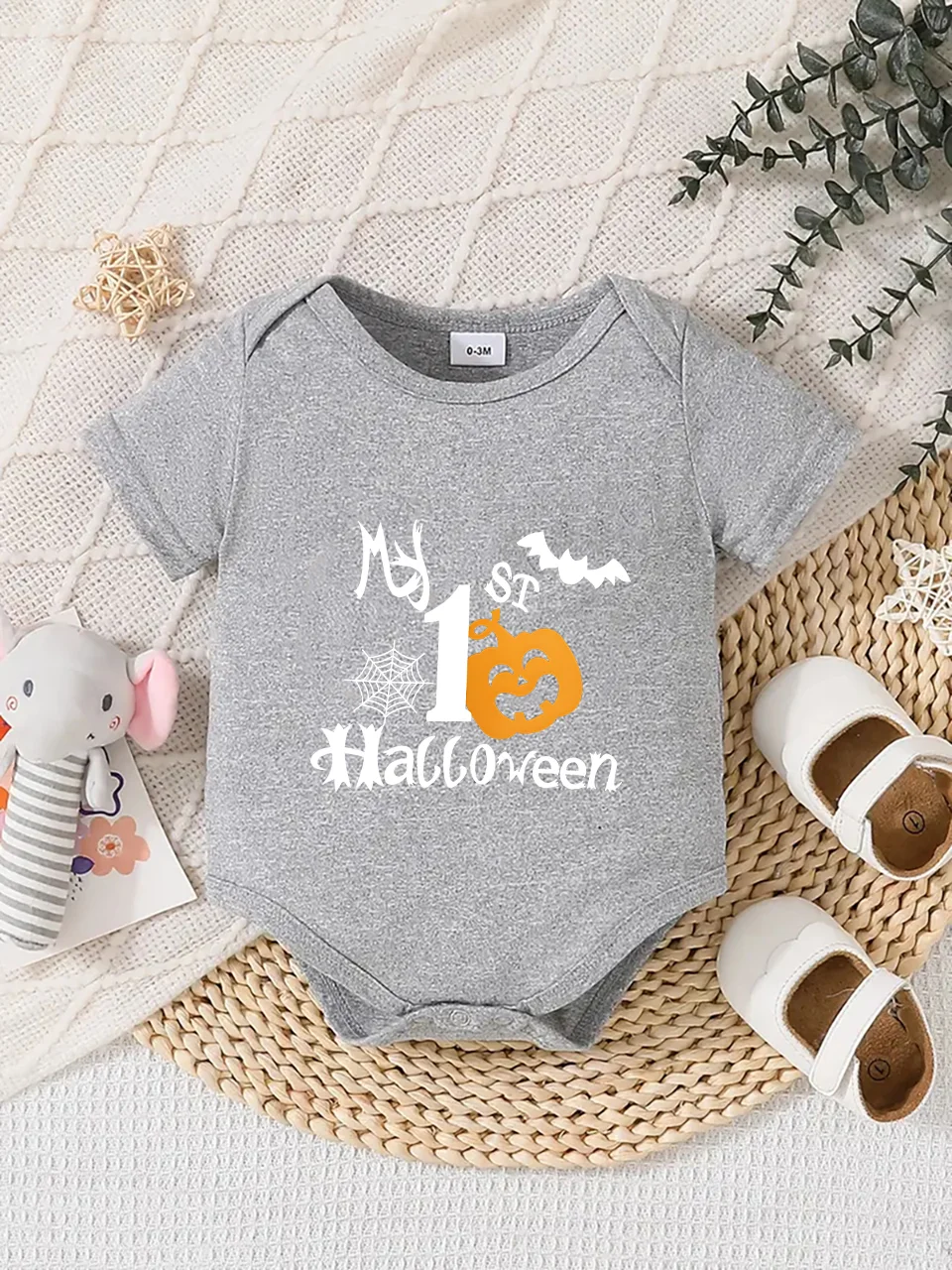 Playful letter-printed baby short-sleeve triangle bodysuit. Button closure for easy dressing
