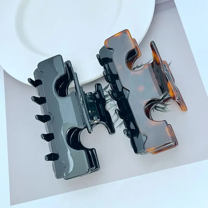 

Minimally designed commuting candy colored grab clip with dual tone back of the head shark clip