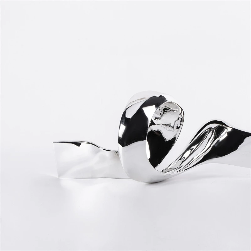 

Rotary twist electroplated silver ornament