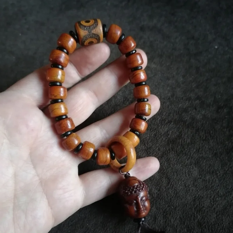 

Antique ox bone Buddhist beads, paired with a three-eyed dzi and a horn bead, symbolizing a single moment of contemplation
