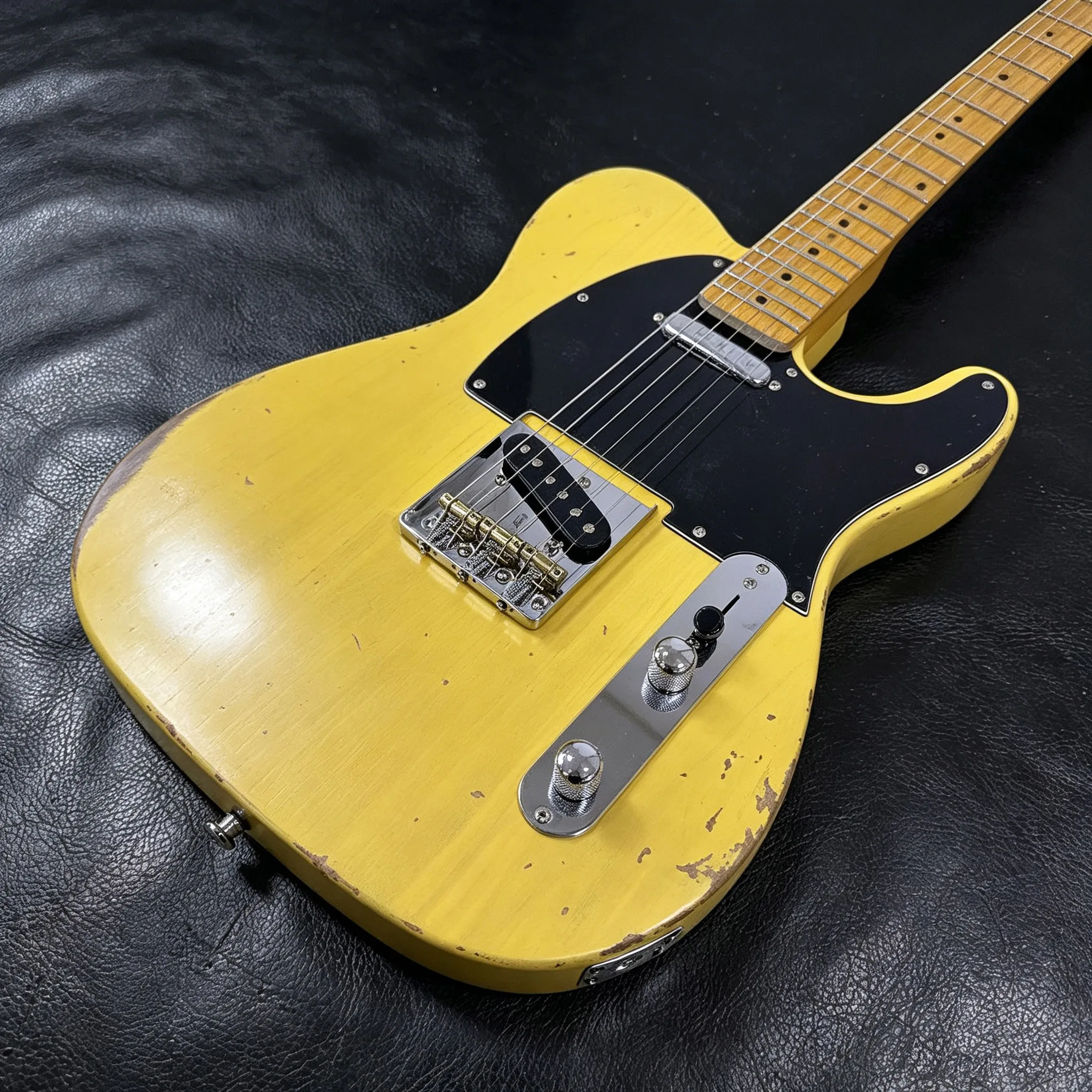 Vintage Relic Tele Style Electric Guitar. Features Butterscotch Yellow Aged Finish, Black Pickguard, Maple Neck, SS Single Coil Pickups And Chrome Hardware. Great Choice For Blues, Country And Vintage Rock Players. Available In Stock, Free Shipping.
