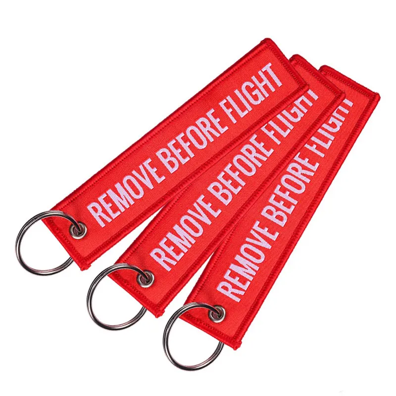 100Pcs Embroidery REMOVE BEFORE FLIGHT Rectangle Keychain Motorcycle Key Chain Accessories Souvenir Wholesale