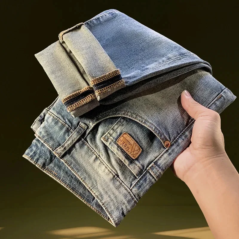 Vaqueros de mezclilla rasgados de nueve puntos para hombre en el verano de 2026, pantalones elásticos de pierna estrecha lavados retro de marca delgada y de moda