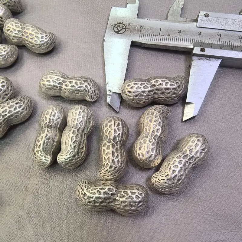 A silver peanut-shaped furniture tabletop ornament