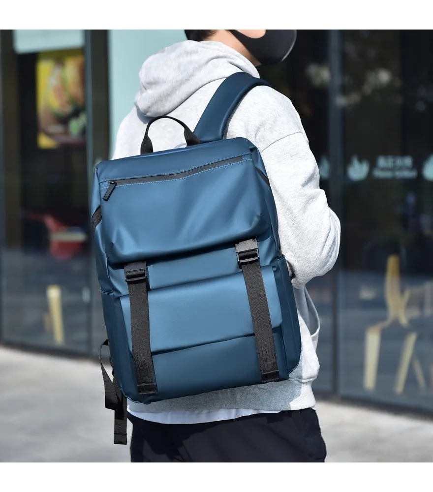Blue workwear style backpack roll top closure with black straps front slip pocket matte waterproof surface for men street style