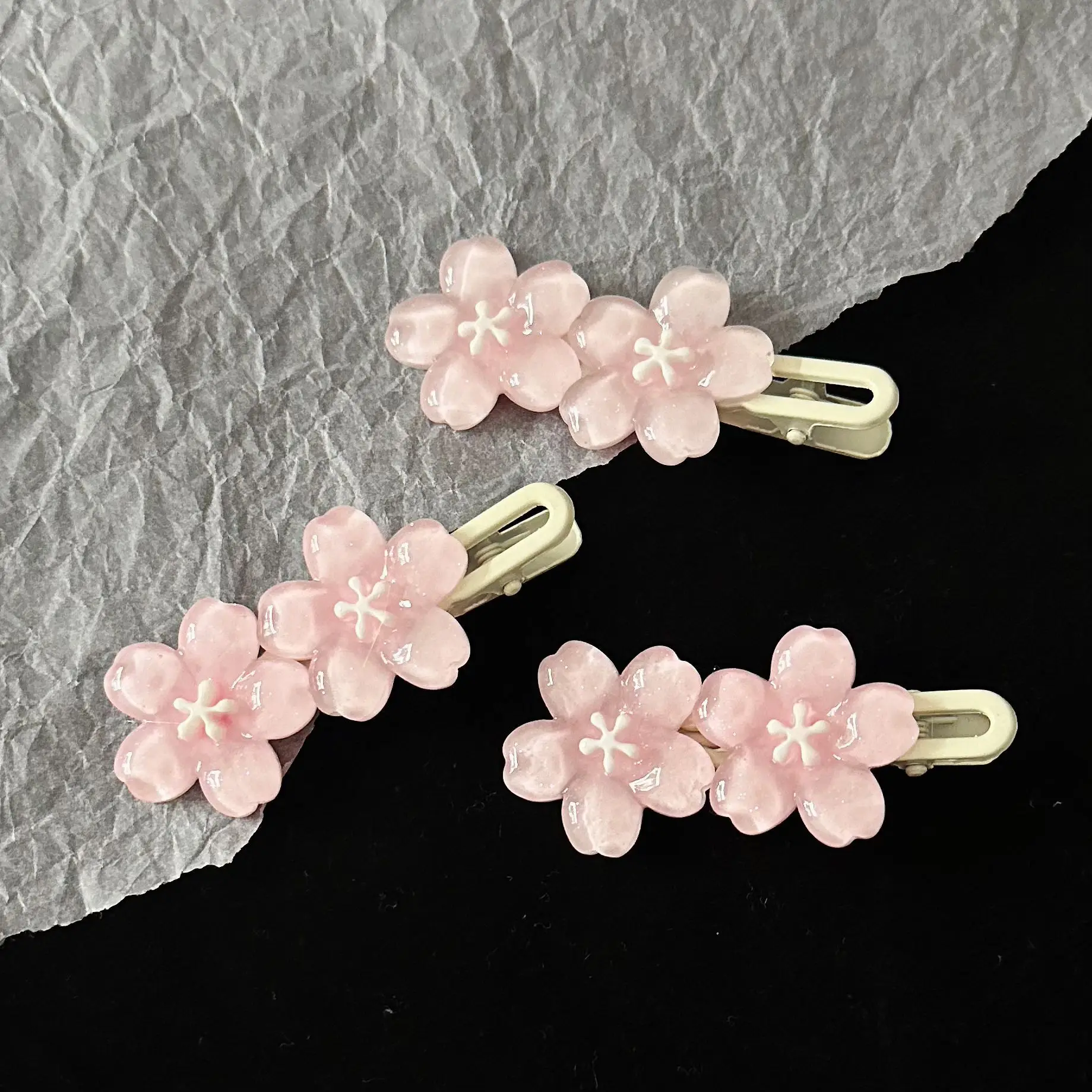 Romantic pink cherry blossom hair clip, perfect for girl's bangs and side hair accessories. Available for wholesale