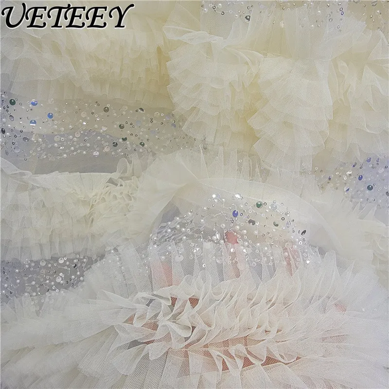 กระโปรงยาวทรงเค้กแต่งระบายผ้าทูลล์ประดับเลื่อมเอวสูงยางยืด สไตล์แฟชั่นใหม่รับฤดูใบไม้ผลิปี 2026 สีแอปริคอต ดีไซน์อเนกประสงค์สำหรับผู้หญิง