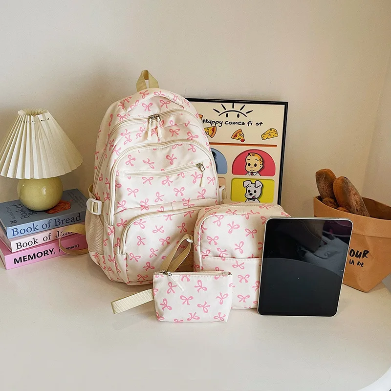 ชุดกระเป๋าเป้สะพายหลังลายโบว์น่ารักสำหรับเด็กผู้หญิง 3 ชิ้น น้ำหนักเบา เรียบง่าย เหมาะสำหรับนักเรียน  กระเป๋าเดินทางใส่โน้ตบุ๊คได้  จุของได้เยอะ