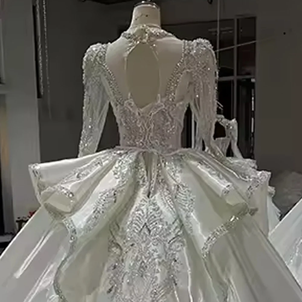 فستان زفاف طويل من Robe De Mariée بأكمام طويلة ورقبة على شكل V مطرز بالخرز من الكريستال برباط علوي وفتحة خلفية فستان زفاف طويل فيستدو دي نوفيا
