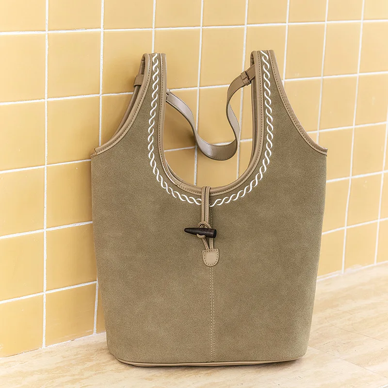 

2025 модная портативная корейская версия сплошной цвет текстурированная повседневная универсальная сумка-ведро на плечо с нишевым дизайном