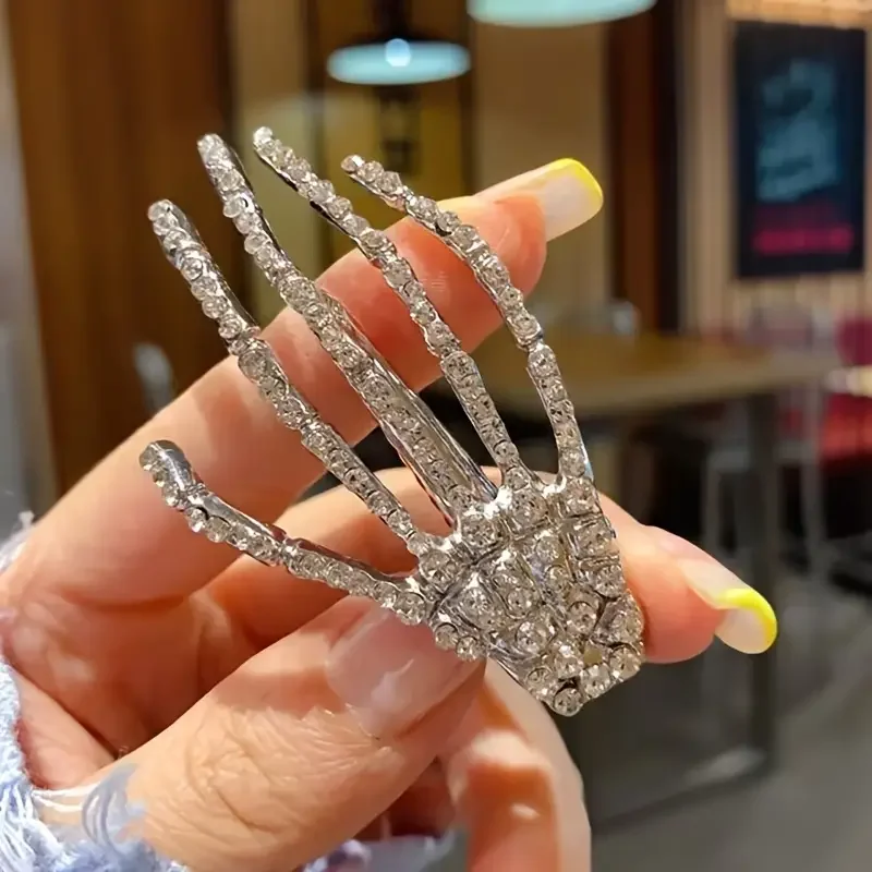 

Готическая заколка для волос в стиле ужасов со сверкающими стразами и элегантным дизайном пальца черепа.