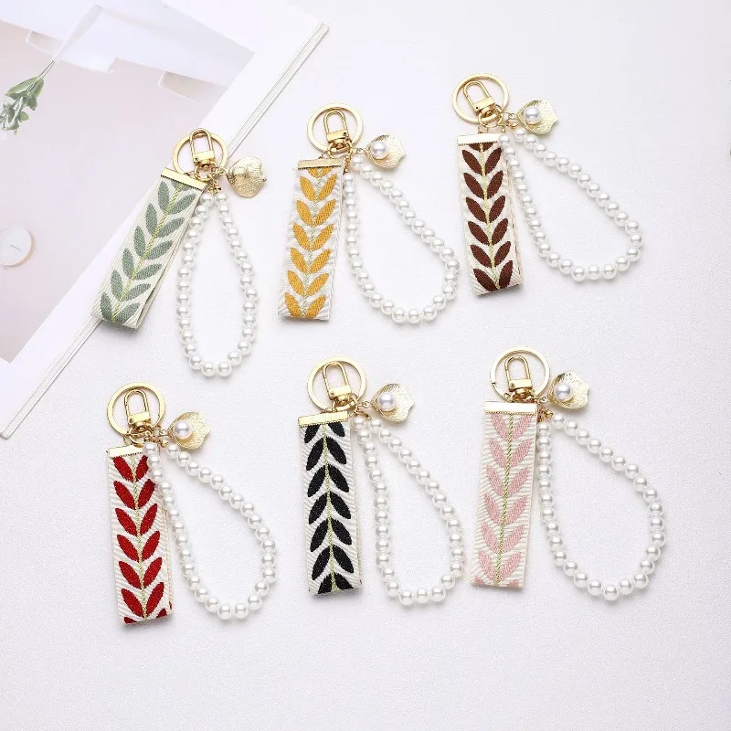 Trending 2025 Keychain Set Fashion Minimalist Pearl Car Keychain Woven Stripe Bag Charm Elegant Women Keychain Organizer Gift