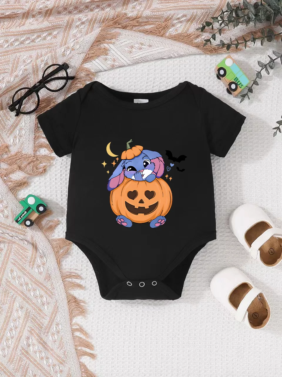 Playful letter-printed baby short-sleeve triangle bodysuit. Button closure for easy dressing, machine washable