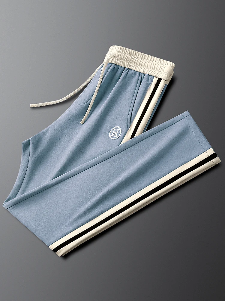 

Голубые мужские повседневные спортивные брюки, осенние эластичные брюки на талии в стиле пэчворк с боковой полоской, против морщин, модные прямые брюки...