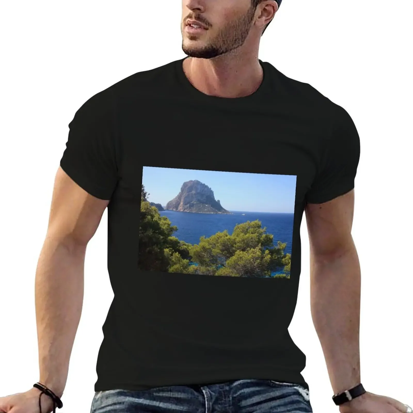 The solitary islet of Es Vedra in contrast against the blue sea of ??Ibiza immersed in the green and arid wild nature in T-Shirt