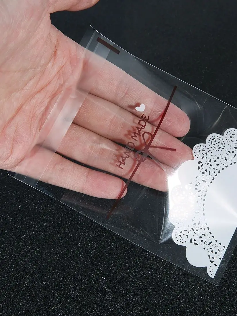 Sacs cadeaux auto-scellants avec nœud en dentelle, sacs d'emballage de bijoux en plastique OPP transparent, pocommuniste de rangement pour strass et bonbons, 100 pièces/lot
