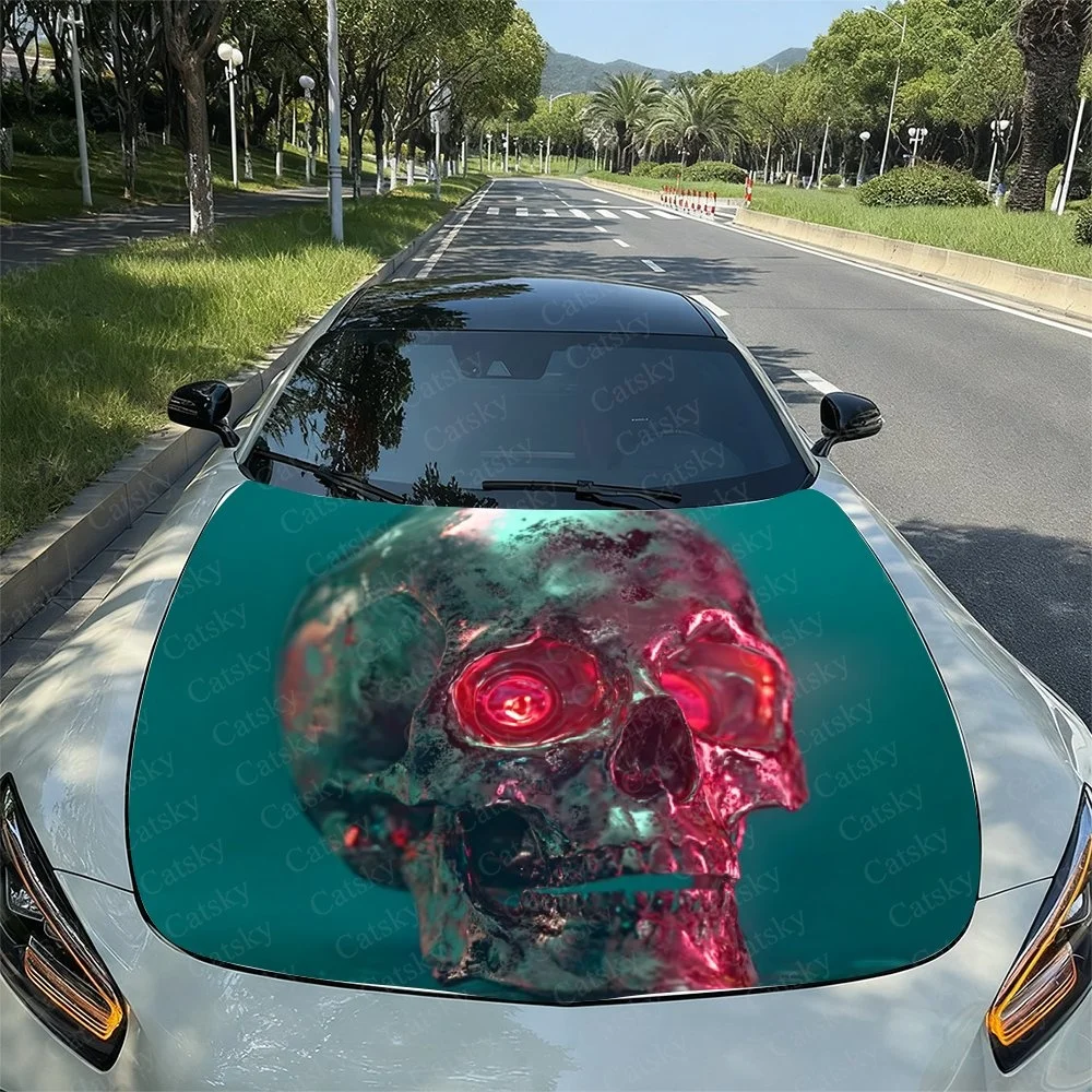 Glowing red-eyed skull design on a teal car hood. Perfect for edgy, bold aesthetics. Adds unique flair to any vehicle.Car sticke