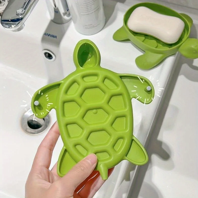 A cute turtle-shaped soap dish for draining soap in the bathroom sink.