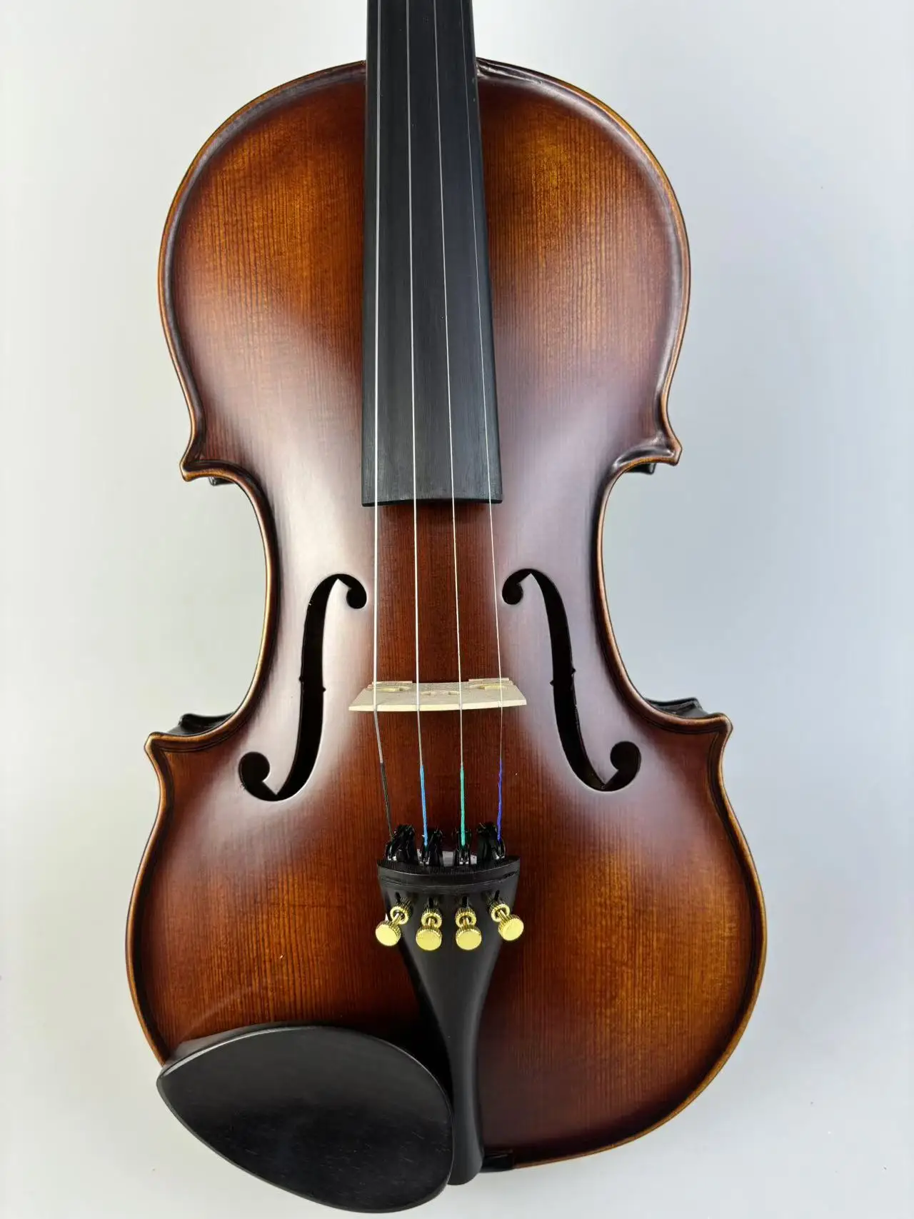 4/4 violin with camel colored box, octagonal bow, solid wood shoulder support, spare strings