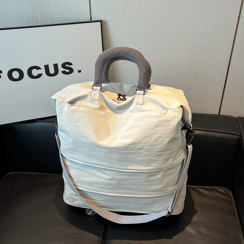 大容量トラベルバッグ、取り外し可能なユニバーサルホイール付き、拡張可能なハンドヘルド収納バッグ、カラーブロックフィットネスバッグ、クロスボーダー