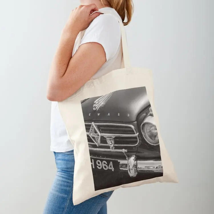 

A black and white image of the front of a 1959 Borgward Isabella on display at a car show Tote Bag Shopper tote bags men