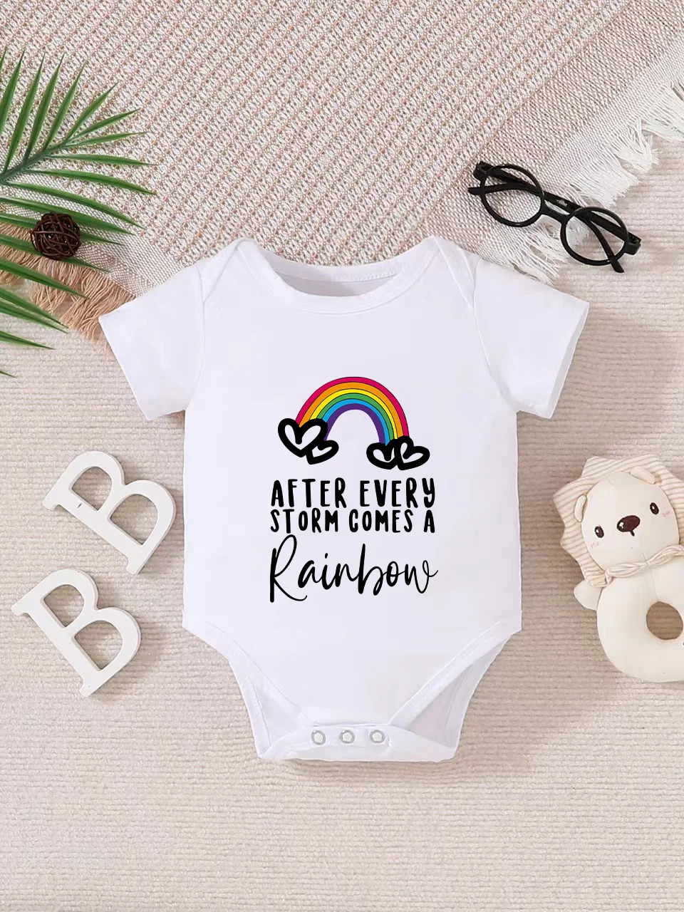 

Playful letter-printed baby short-sleeve triangle bodysuit. Button closure for easy dressing, machine washable