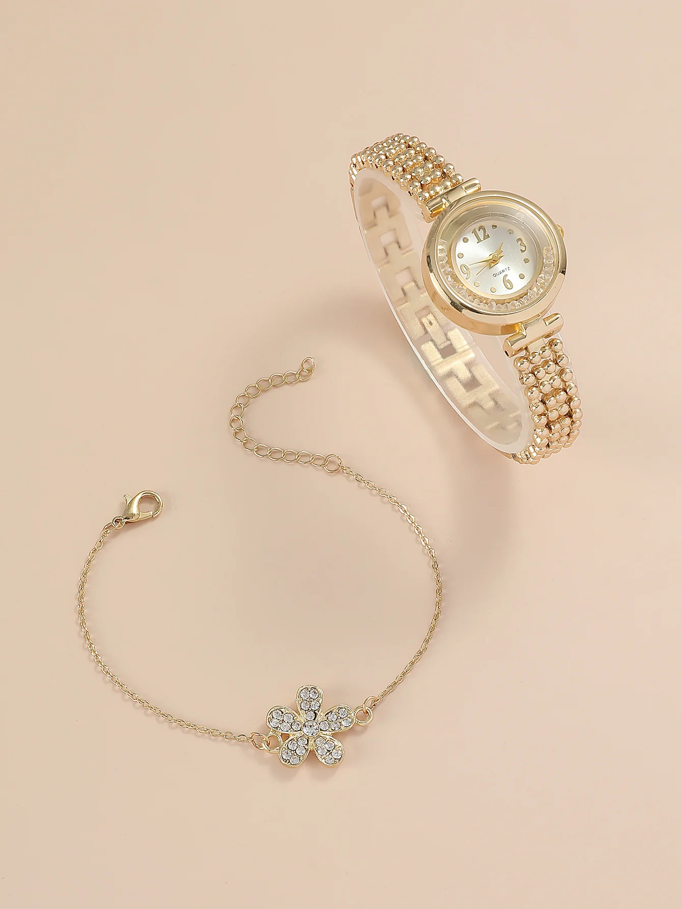 A Gold Women\'s Classic Fashion Quartz Watch With A Ball Bracelet And A Rhinestone Plum Bracelet. Can Be Used For Daily Wear