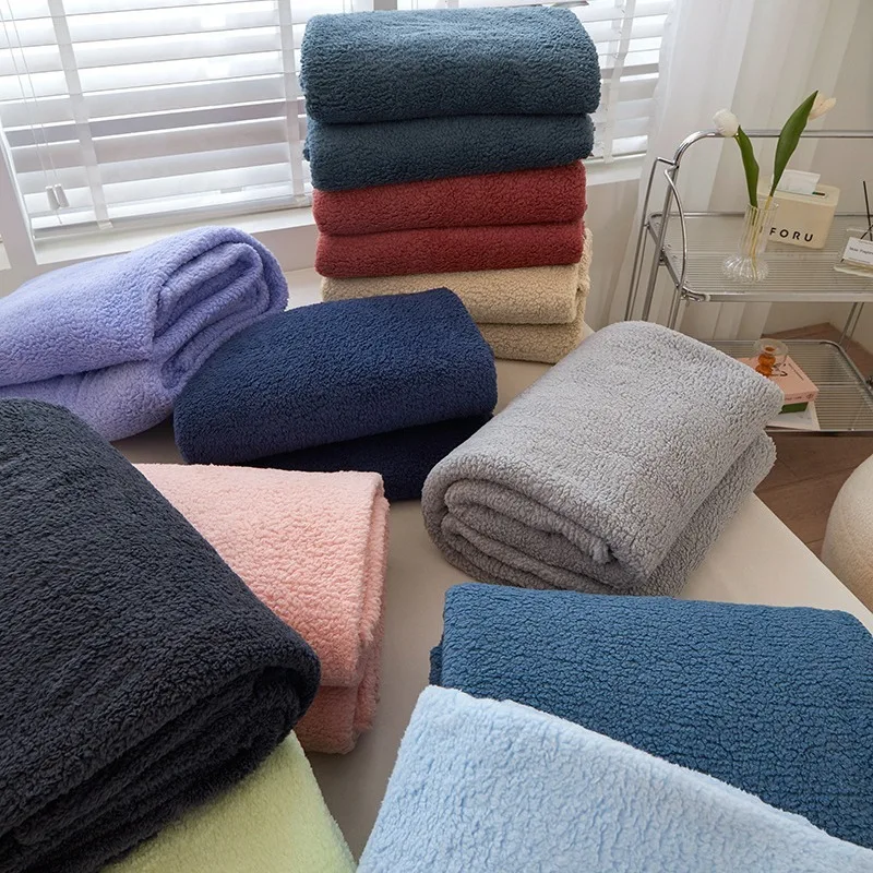

Embrace of Softness: Solid Color Coral Fleece Throw. Your All-Season Snuggle Companion for Couch & Bedside Comfort.