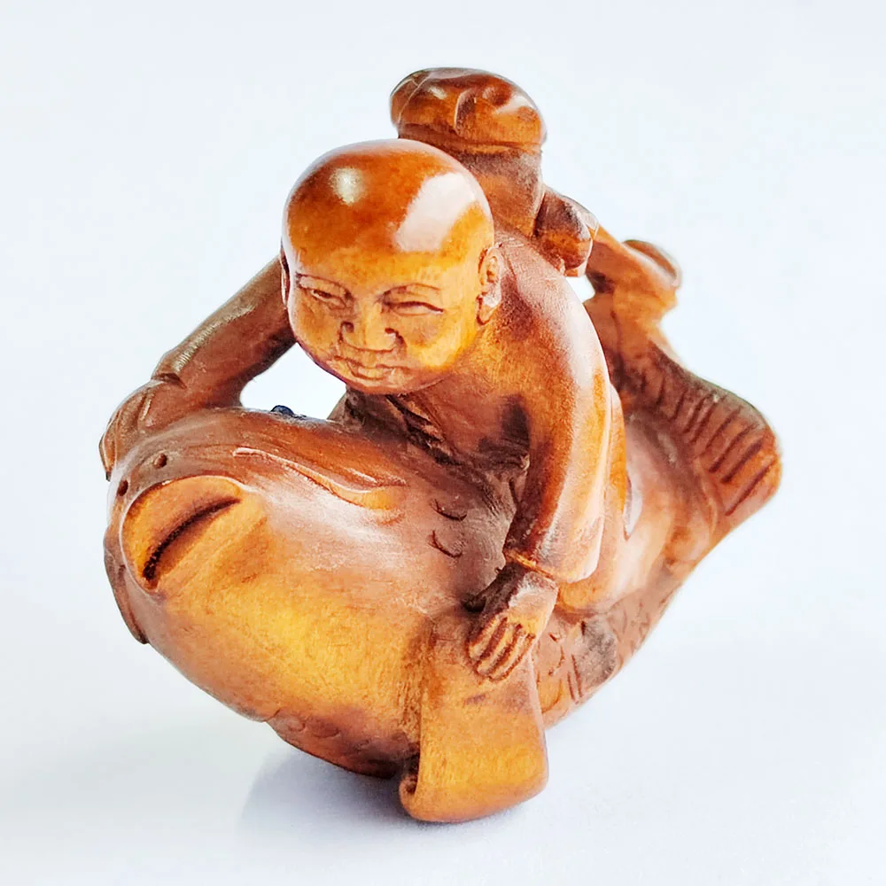 

Y8333 - 2" Hand Carved Boxwood Netsuke - Monk Boy on Fish